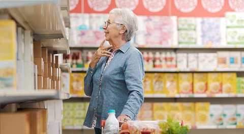 señora mirando el lineal de un supermercado
